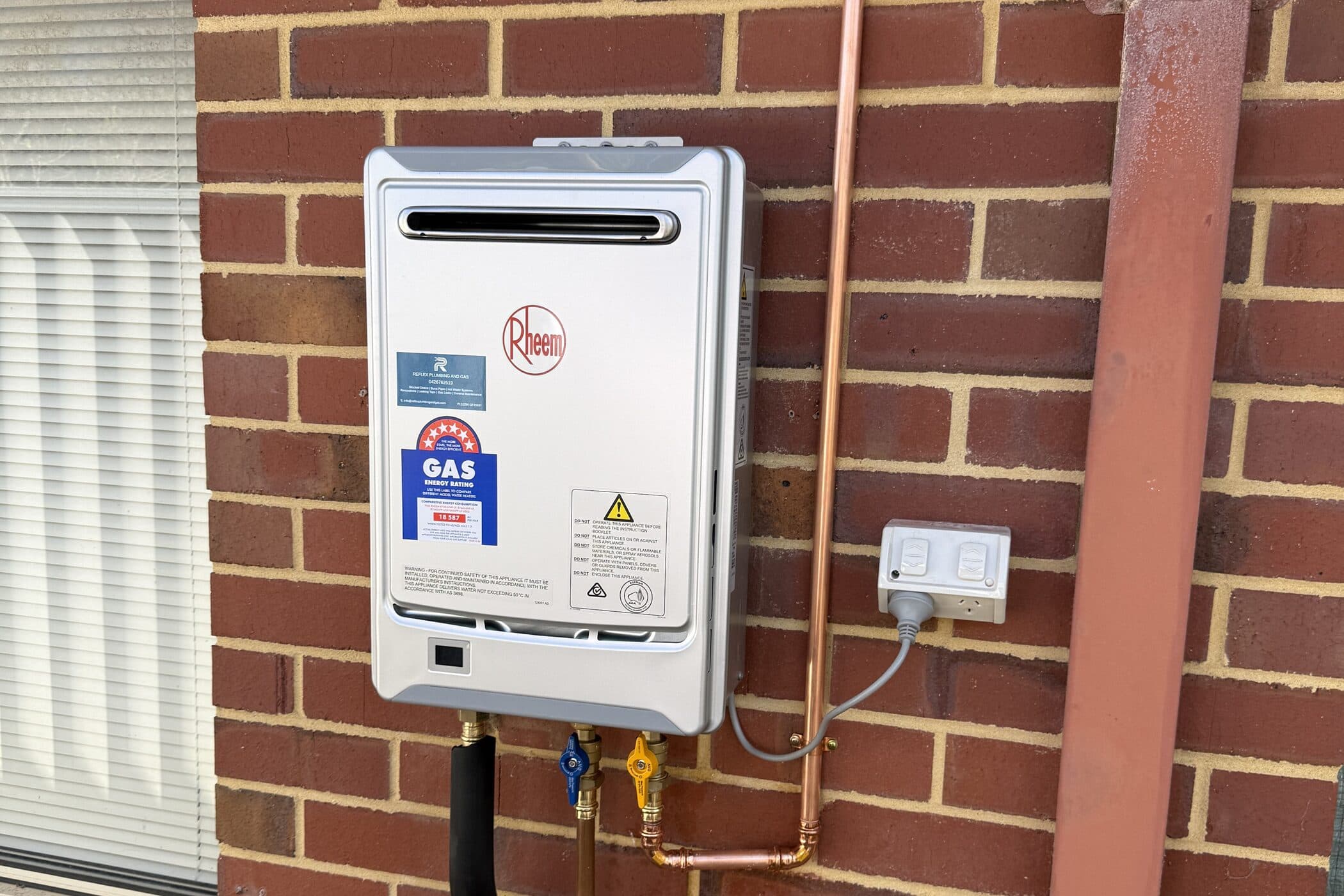 A newly installed hot water system on the external wall of a Perth home