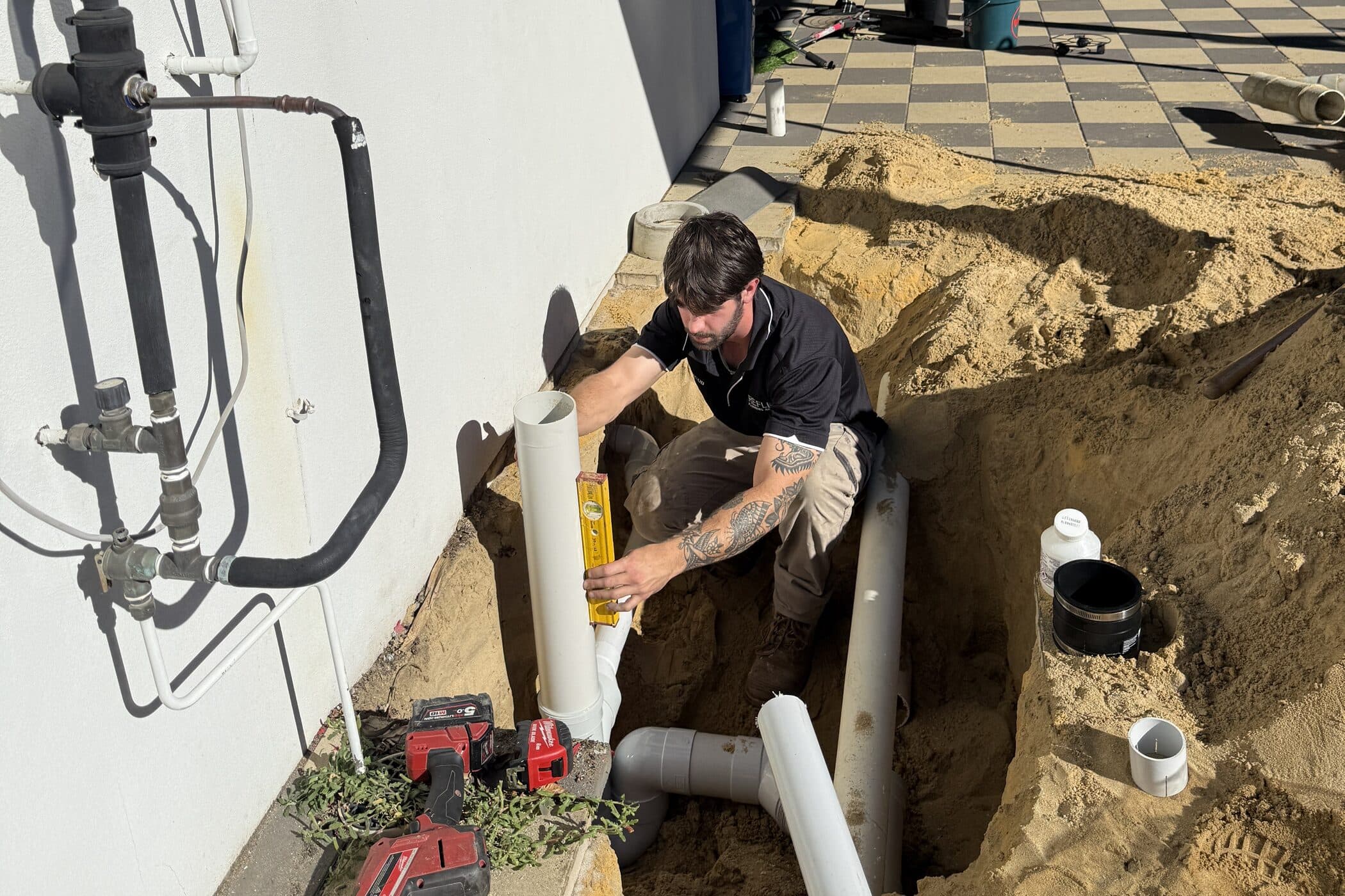 An excavation beside a Perth home with the pipework opened up during a leak repair