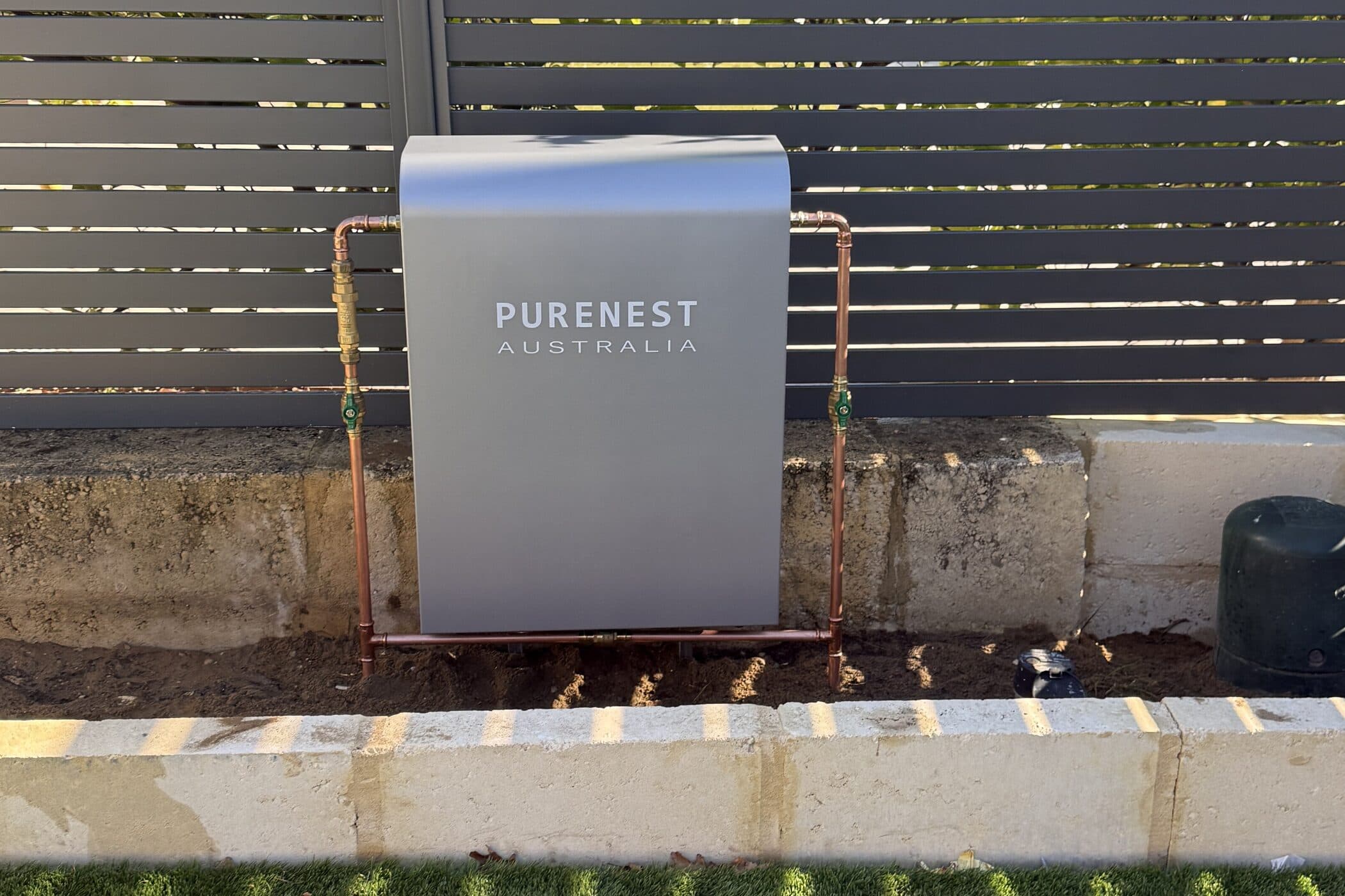 An under-sink water filtration system installed in a kitchen cupboard