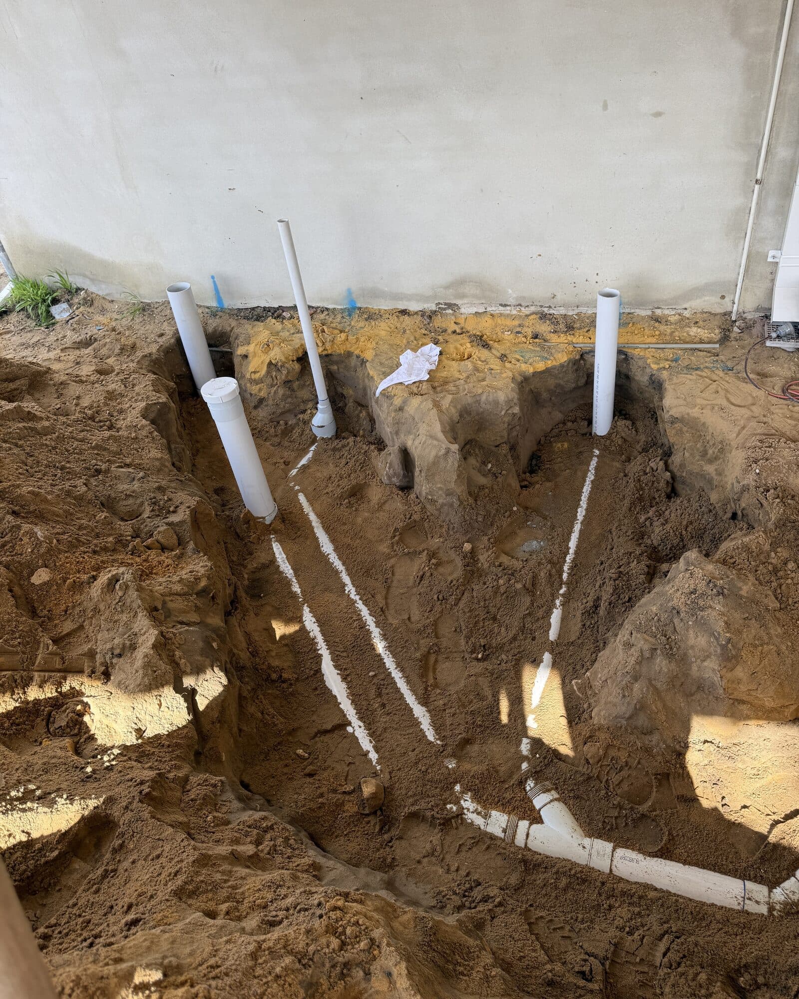 Sewer pipework set out in an open trench before backfill